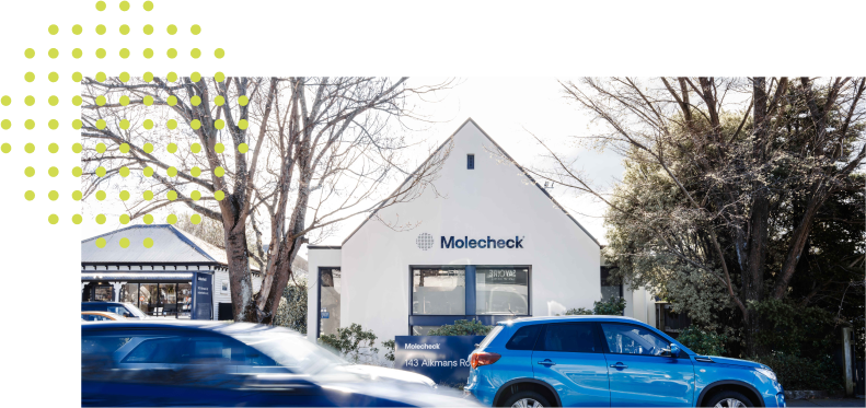 The Christchurch Molecheck building with two cars in the foreground.